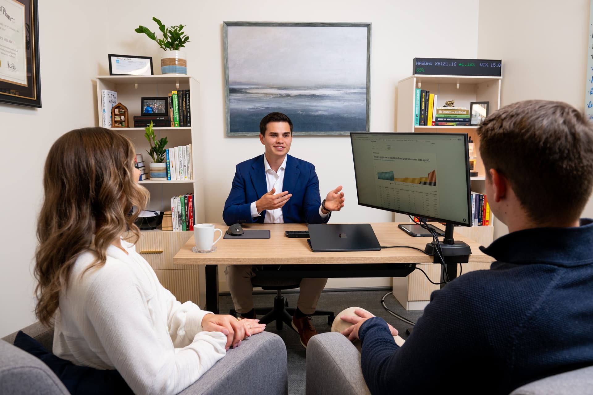 Chris Villaire, fiduciary financial advisor, meeting with clients in his Grand Rapids office